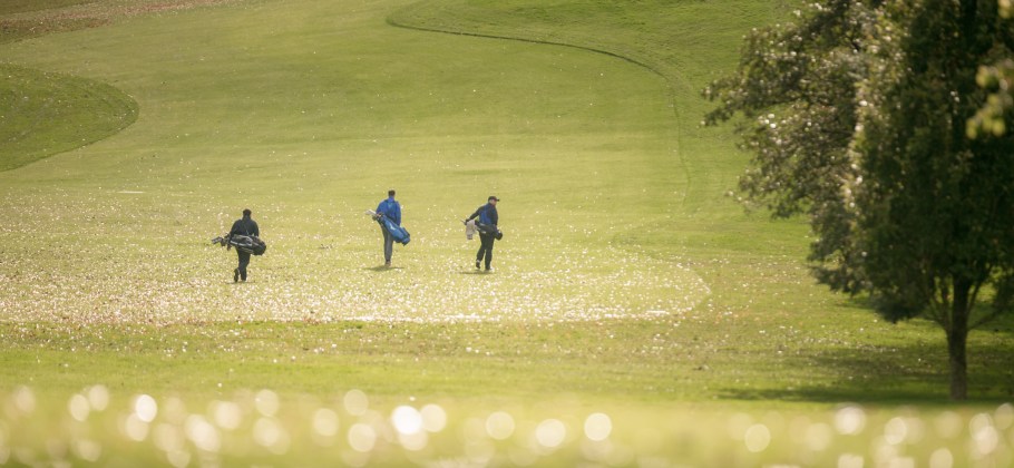 Golfers walk the course for a 9-hole round